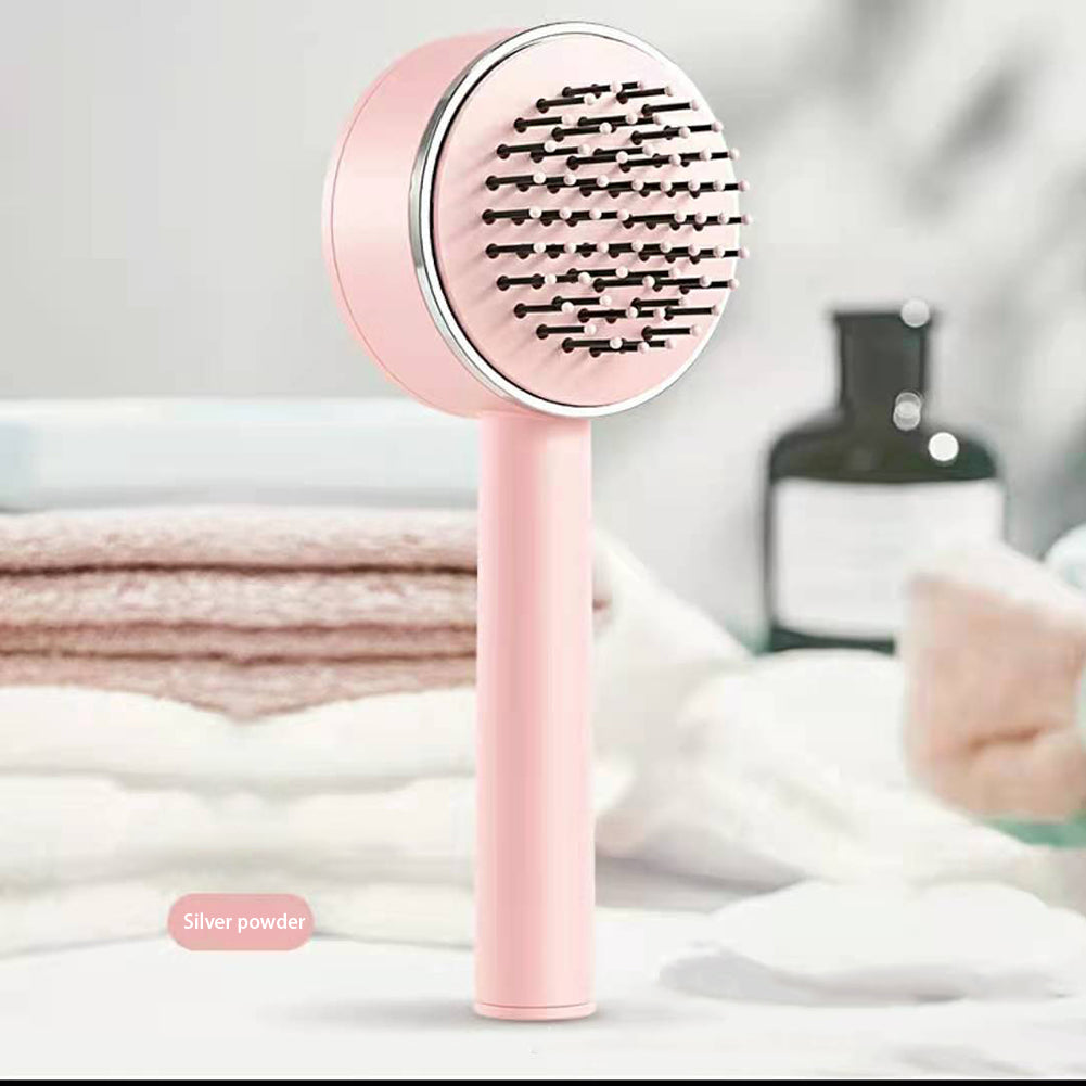 Self-cleaning air cushion hairbrush in pink — lifestyle shot on bathroom shelf